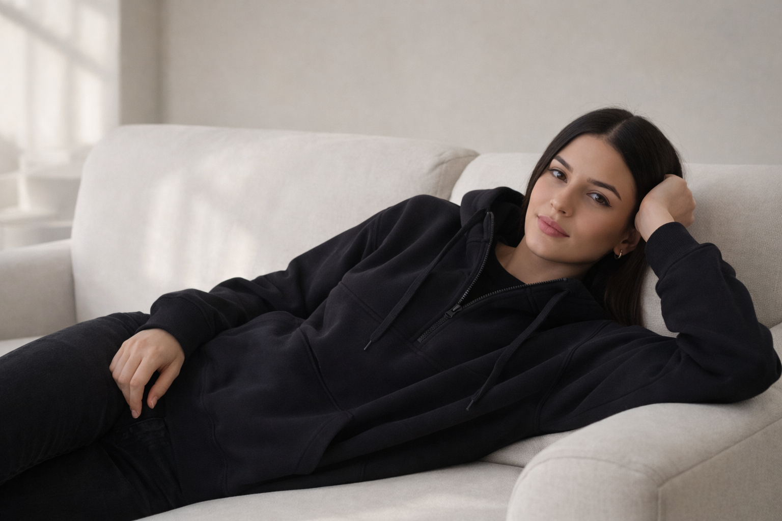 woman laying on the couch wioth weighted hoodie